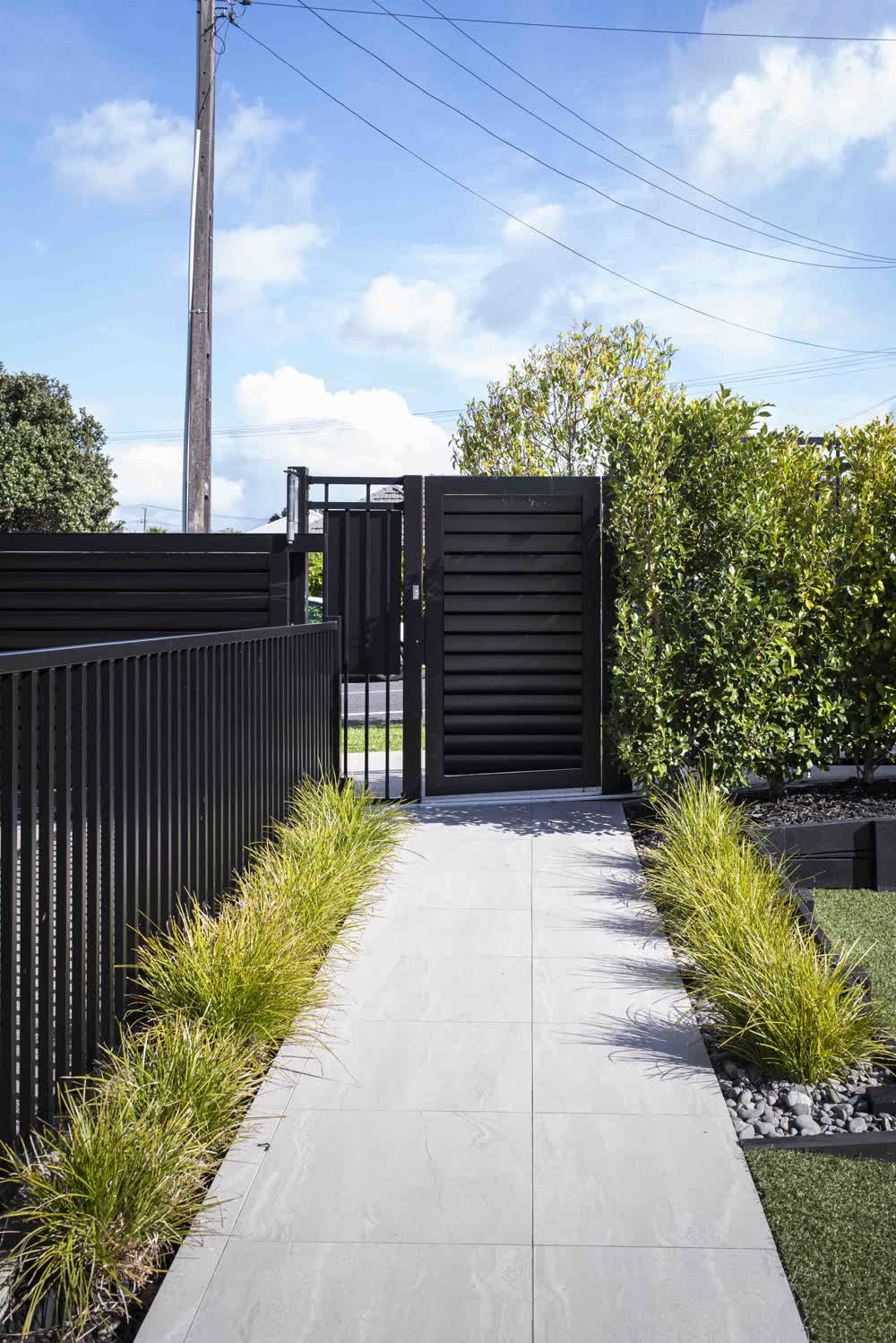 Paved path to front gate with tidy planting